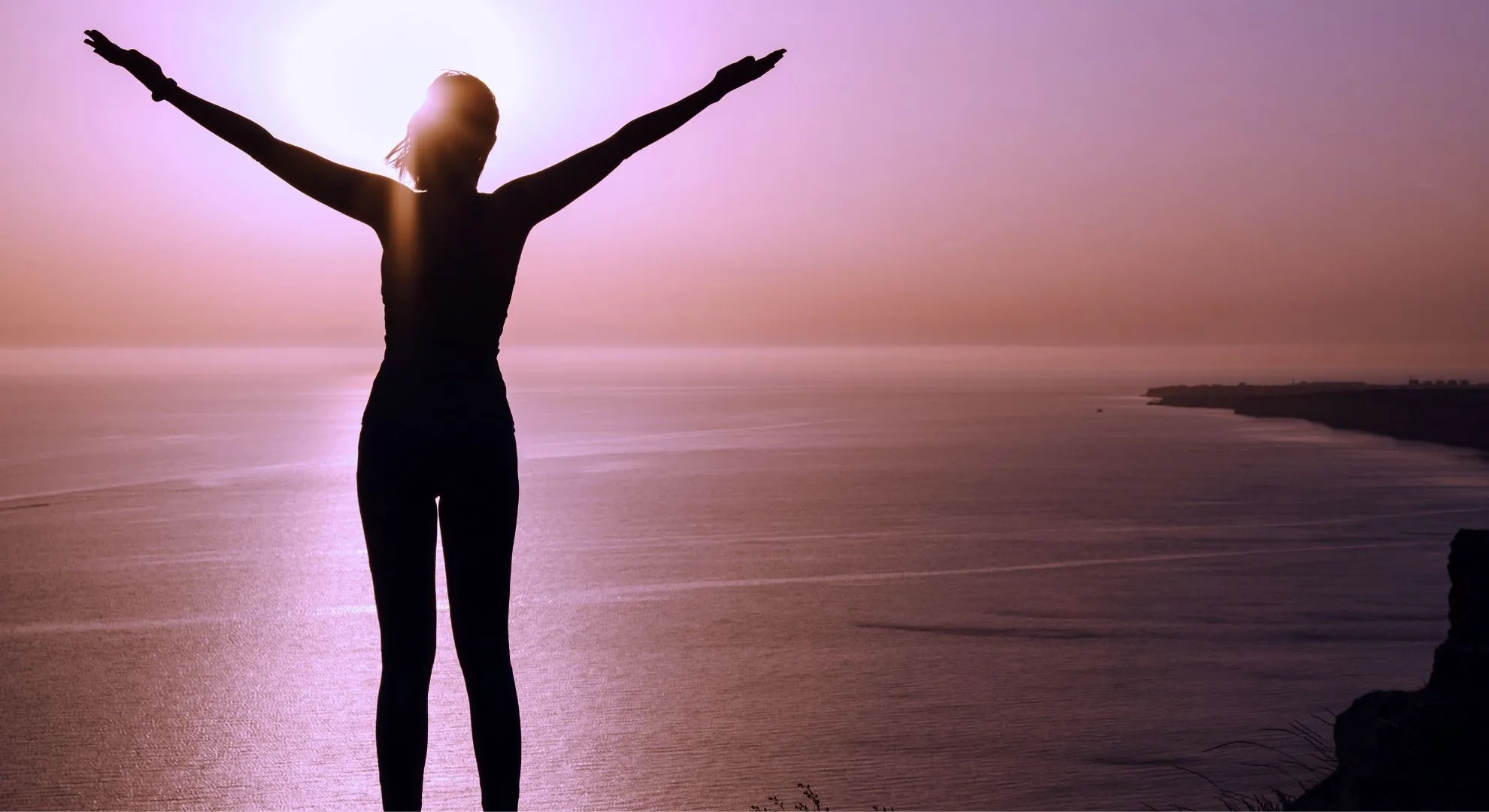 woman stretching in front of beach