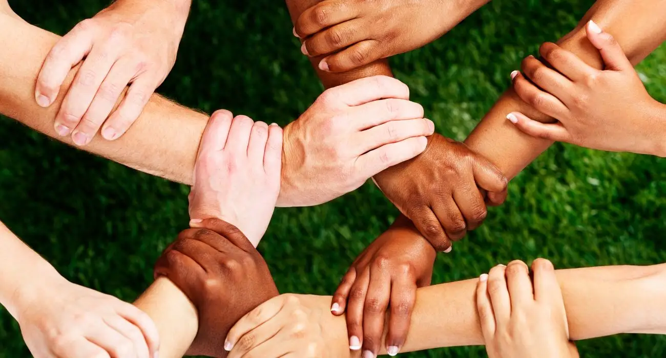 people holding hands showing strength and unity